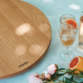 Bild in Galerie-Betrachter laden, Drehteller aus Eichenholz Natur, Größe XL, 75cm Durchmesser, rund, COOKX Logo eingraviert, Milieubild im Garten, Teller steht auf Tisch
